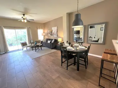 a living room with a table and chairs and a couch at Sun Key Getaway in Kissimmee
