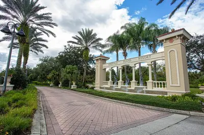 a gate in a park with palm trees at Magari at Emerald Island in Kissimmee