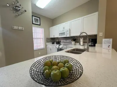 a bowl of green apples sitting on a kitchen counter at Americana at Emerald Island in Kissimmee