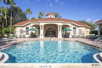 a large swimming pool in front of a house at Americana at Emerald Island in Kissimmee