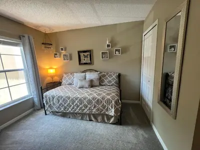 a bedroom with a bed and a window at Americana at Emerald Island in Kissimmee