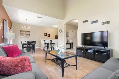 a living room with a couch and a tv at The Beauty at Emerald Island in Kissimmee