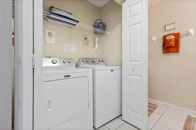 a laundry room with a washer and dryer at The Beauty at Emerald Island in Kissimmee