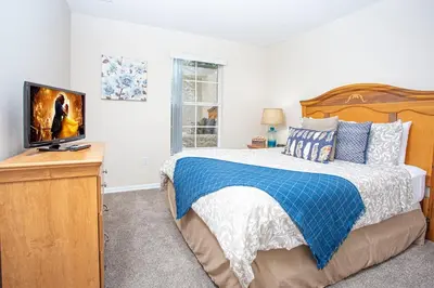 a bedroom with a bed and a flat screen tv at Bella Vista at Emerald Island in Kissimmee