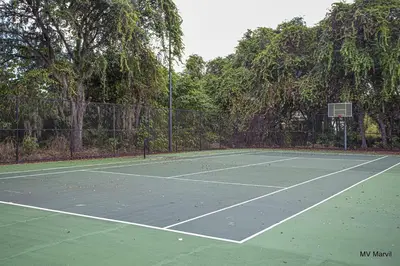 a tennis court with a net on top of it at Bella Vista at Emerald Island in Kissimmee