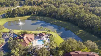 an aerial view of a house and a lake at Bella Vista at Emerald Island in Kissimmee