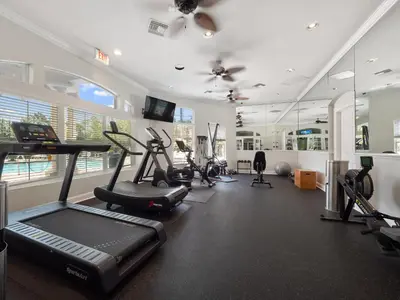 a gym with treadmills and exercise equipment in a room at Asteria at Emerald Island in Kissimmee