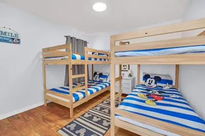a bedroom with two bunk beds and a rug at Sunny Side Up in Orlando