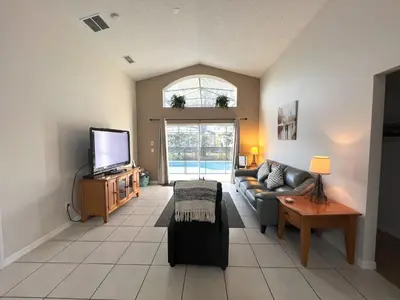 a living room with a couch and a tv at The Haven in Kissimmee
