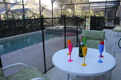 a table with three wine glasses on a patio at The Haven in Kissimmee