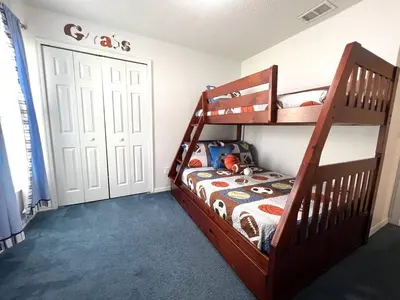 a bedroom with two bunk beds and a door at Oasis Key Retreat by PropertyChekker! in Kissimmee