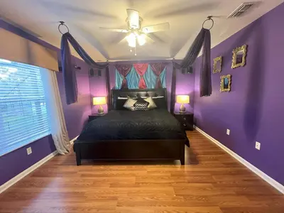 a purple bedroom with a bed and a ceiling fan at Mickey's Castle by PropertyChekker! in Orlando