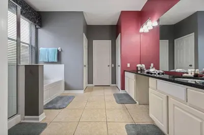 a large bathroom with a sink and a tub at Mickey's Castle by PropertyChekker! in Orlando