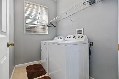 a white washer and dryer in a room at Mickey's Castle by PropertyChekker! in Orlando
