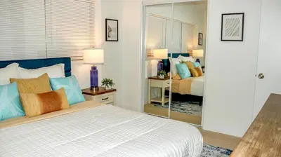 a bedroom with a bed and a mirror at Orlando Villa: Pool Garage & Garden View in Orlando