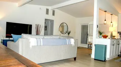 a living room with a large bed and a kitchen at Orlando Villa: Pool Garage & Garden View in Orlando