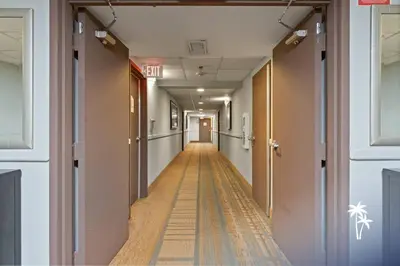 an empty hallway with a long hallway with a corridorngthngthngthngthngthngth at Fireworks View Studio Condo with Terrace and Kitchenette in Orlando