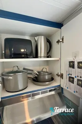 a kitchen with two pots and pans on a shelf at Fireworks View Studio Condo with Terrace and Kitchenette in Orlando