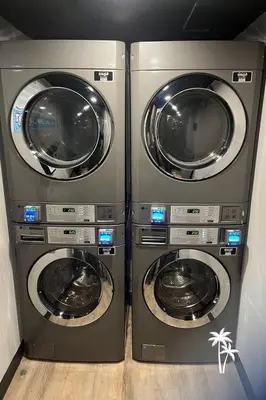 two washing machines are sitting next to each other at Relaxing 2 Bed 2 Bath Condo with Garden View Balcony 7 Min to Universal in Orlando