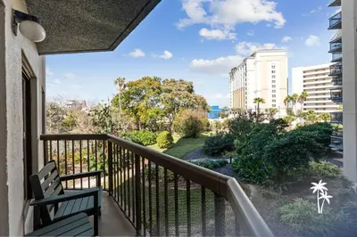 a balcony with a bench and a view at Relaxing 2 Bed 2 Bath Condo with Garden View Balcony 7 Min to Universal in Orlando