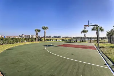 a basketball court with palm trees and a hoop at Lanai and Private Pool, 8 Mi to WDW Family Getaway! in Kissimmee