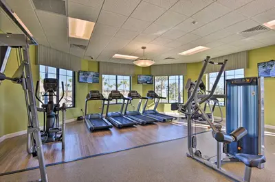 a gym with several treadmills and cardio machines at Lanai and Private Pool, 8 Mi to WDW Family Getaway! in Kissimmee
