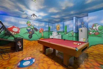 a room with a painting on the wall with a pool table at Free Arcade! All Themed! South Facing Pool & Spa! in Orlando