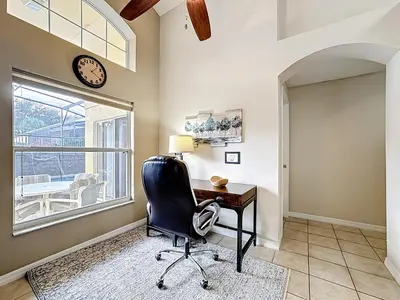 a office with a desk and a chair and a clock at Emerald Island Disney Villa with Pool & Spa in Kissimmee