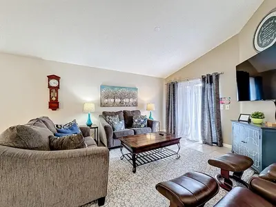 a living room with two couches and a coffee table at Emerald Island Disney Villa with Pool & Spa in Kissimmee