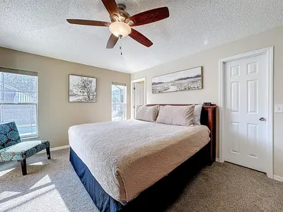 a bedroom with a bed and a ceiling fan at Emerald Island Disney Villa with Pool & Spa in Kissimmee