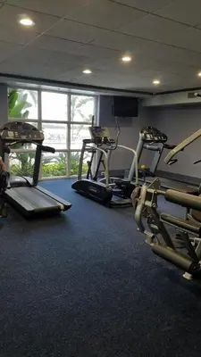 a gym with three treadmills and two ellipticals at Blue Heron Beach Resort 1-809 in Orlando