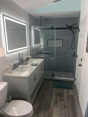 a bathroom with a shower and a toilet and a sink at Woodland Yard in Kissimmee