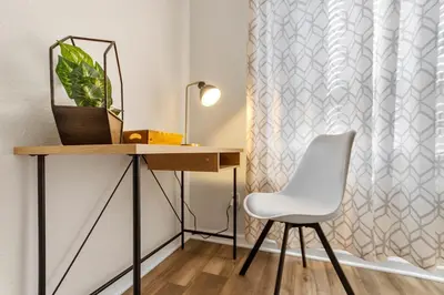 a desk and a white chair in a room at Themed Windsor Hills 6BR Private Pool Gameroom in Orlando
