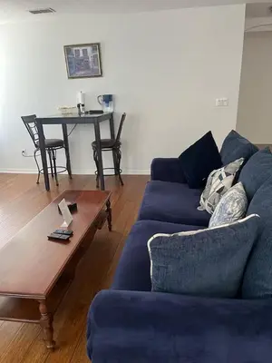 a living room with a blue couch and a table at The Mahal in Sanford