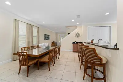 a kitchen and dining room with a table and chairs at Amazing Stay 10 min from Disney in Orlando