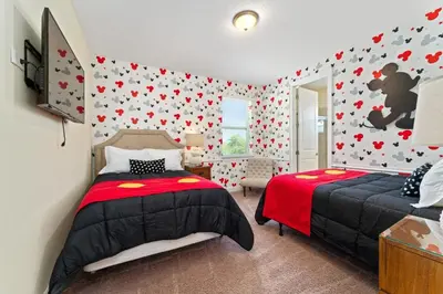 a bedroom with two beds and red hearts on the wall at Amazing Stay 10 min from Disney in Orlando