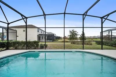 an empty swimming pool in front of a house at Dream 8-Bedroom Home with Pool in Kissimmee