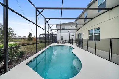 an indoor swimming pool in the backyard of a house at Dream 8-Bedroom Home with Pool in Kissimmee
