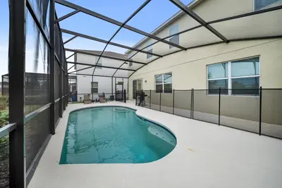 an indoor swimming pool in a building with a glass ceiling at Dream 8-Bedroom Home with Pool in Kissimmee