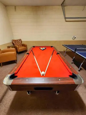 a pool table in a room with two ping pong tables at Spacious 7BR Retreat w Pool & Jacuzzi V#202 in Kissimmee