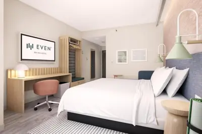 a bedroom with a bed and a desk at EVEN Hotel Orlando Universal Blvd by IHG in Orlando