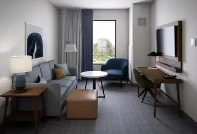 a living room with a couch and a table at Staybridge Suites Orlando Universal Blvd by IHG in Orlando