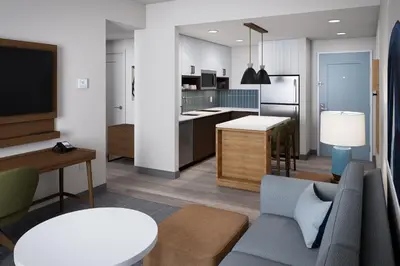 a kitchen and living room with a couch and a table at Staybridge Suites Orlando Universal Blvd by IHG in Orlando