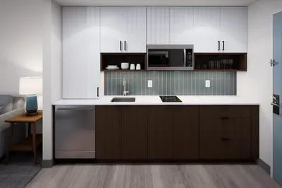 a kitchen with a sink and a microwave at Staybridge Suites Orlando Universal Blvd by IHG in Orlando