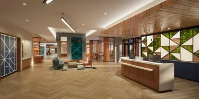 a lobby of a building with a reception desk at Staybridge Suites Orlando Universal Blvd by IHG in Orlando
