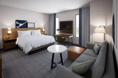 a hotel room with a bed and a couch at Staybridge Suites Orlando Universal Blvd by IHG in Orlando