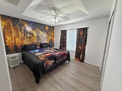 a bedroom with a bed with a painting on the wall at Paradise Cay Resort - Close to Disney in Kissimmee