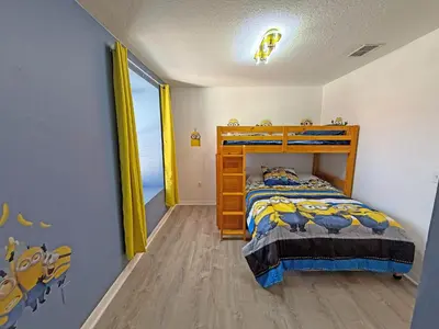 a bedroom with a wooden bed in a room at Paradise Cay Resort - Close to Disney in Kissimmee