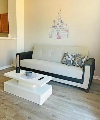 a living room with a couch and a coffee table at Paradise Cay Resort - Close to Disney in Kissimmee