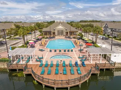 an aerial view of a pool with chairs and a resort at Condo 4Q Seven Dwarfs Resort - Perto da Disney in Kissimmee